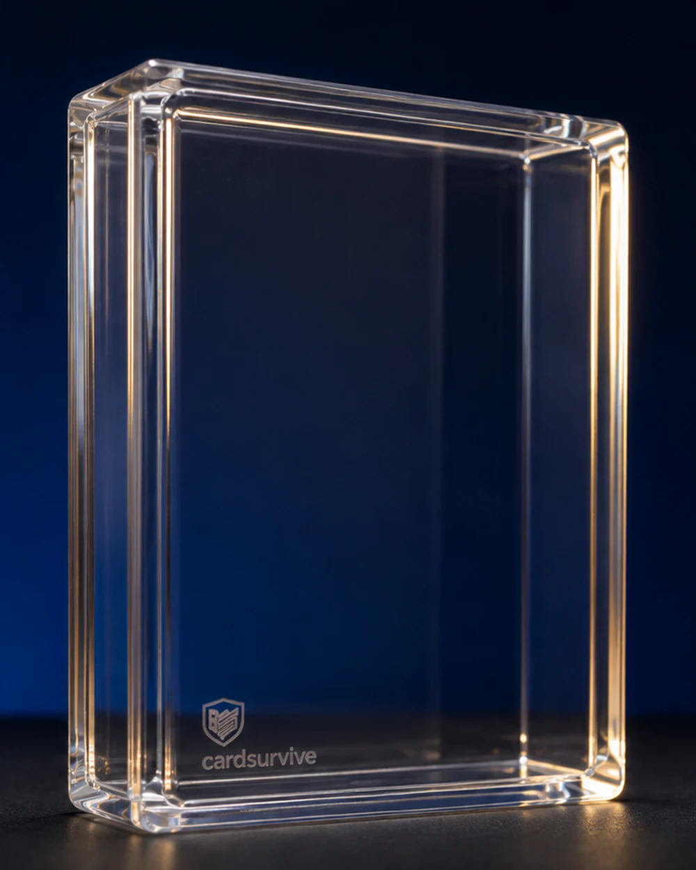 The Tank rigid-acrylic graded-card protector, shown empty from a three-quarter angle.